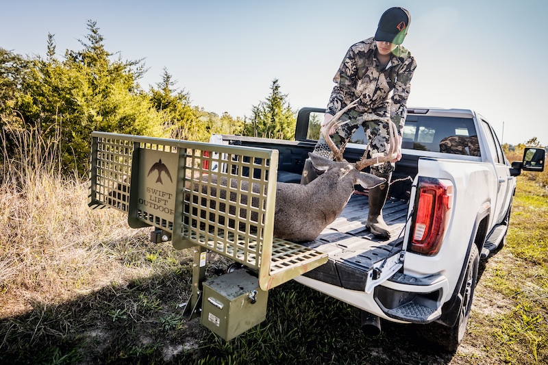 product photo with boy pulling big buck into truck