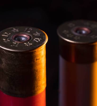 closeup of pictures, piles of rifle bullets on black background